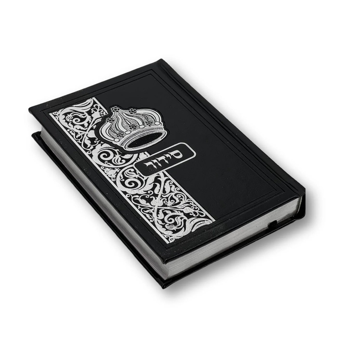 Black faux leather Siddur with an embossed crown and decorative floral design on the cover. The Hebrew word "סידור" appears in silver foil in the center. The book is slightly angled and closed, showing its elegant edges and craftsmanship.