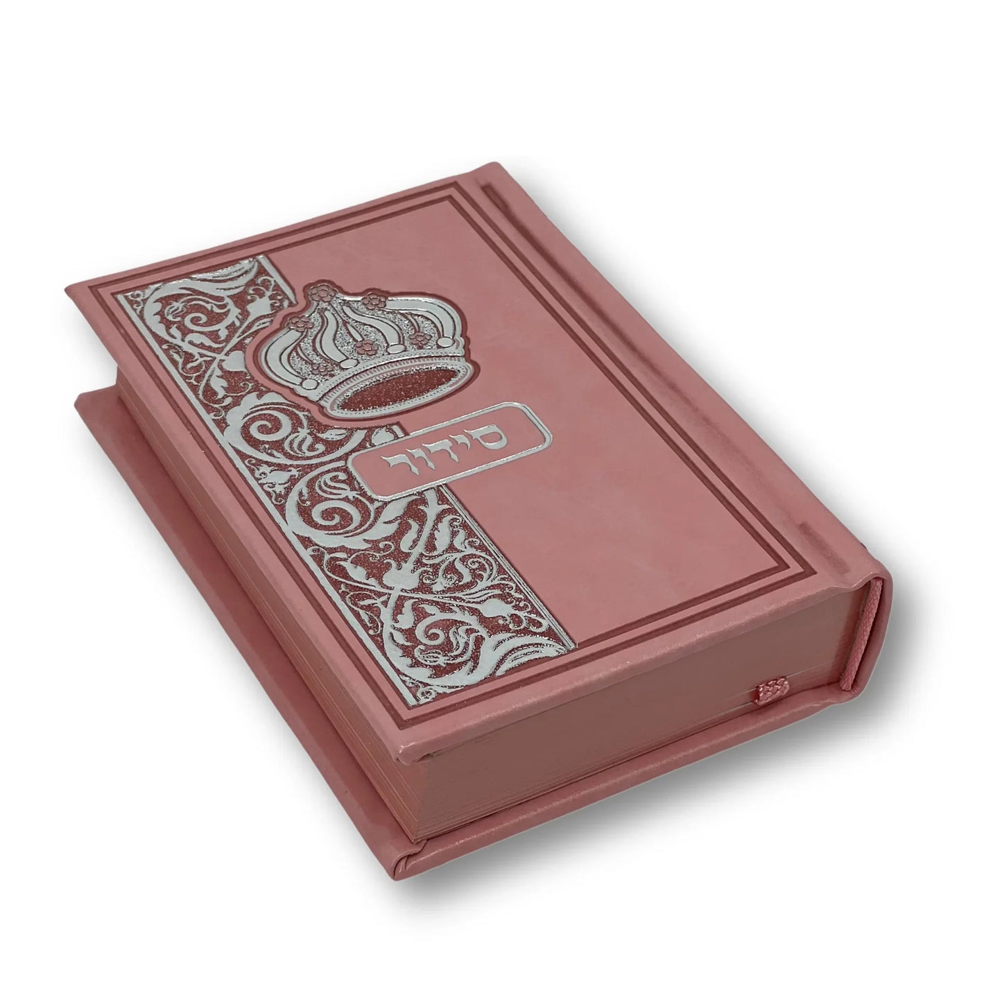 Pink aux leather Siddur with an embossed crown and decorative floral design on the cover. The Hebrew word "סידור" appears in silver foil in the center. The book is slightly angled and closed, showing its elegant edges and craftsmanship.