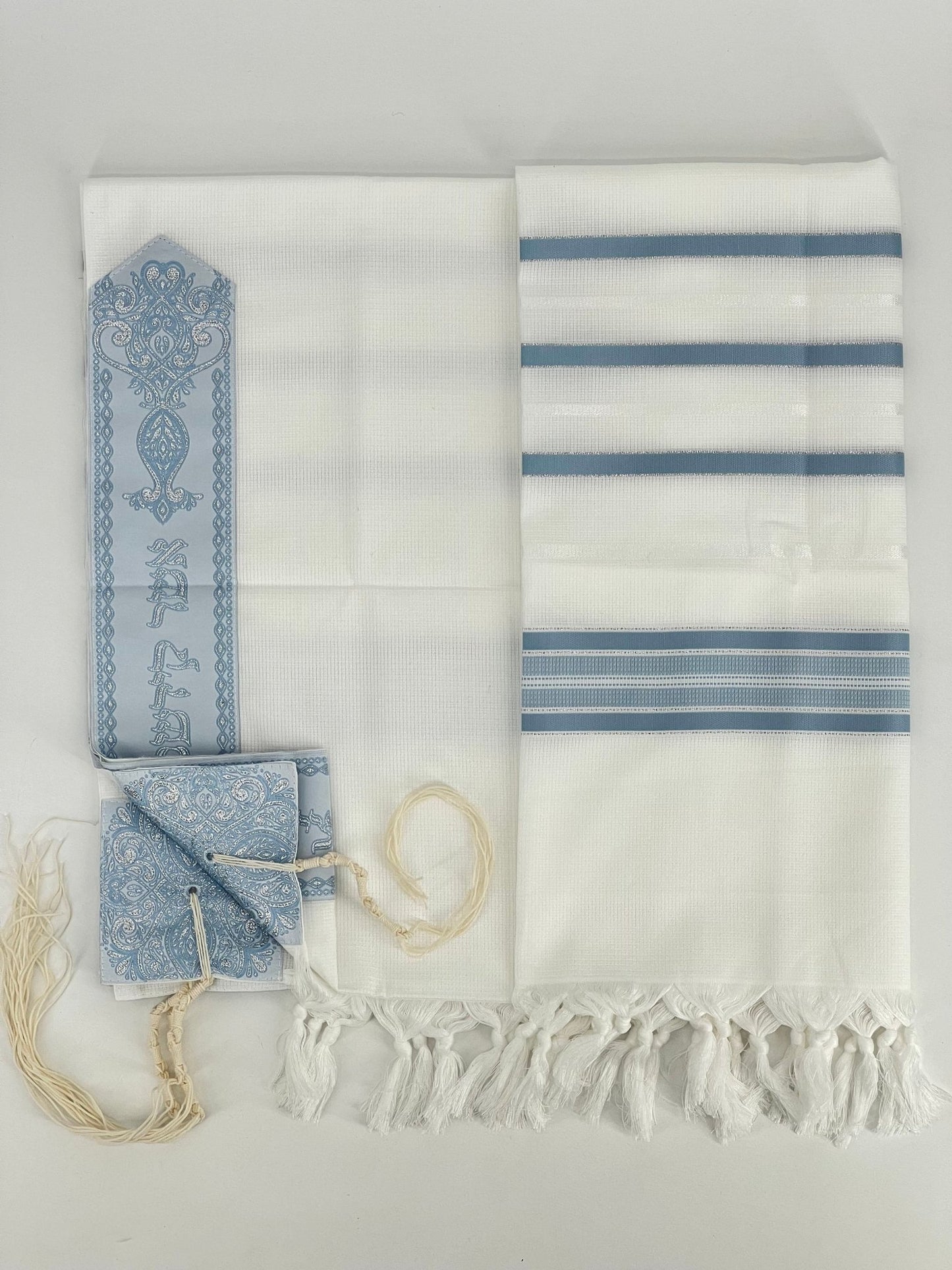 Flat-lay image of a white Acrylic Tallit Chatanim with light blue stripes and silver decorative elements.