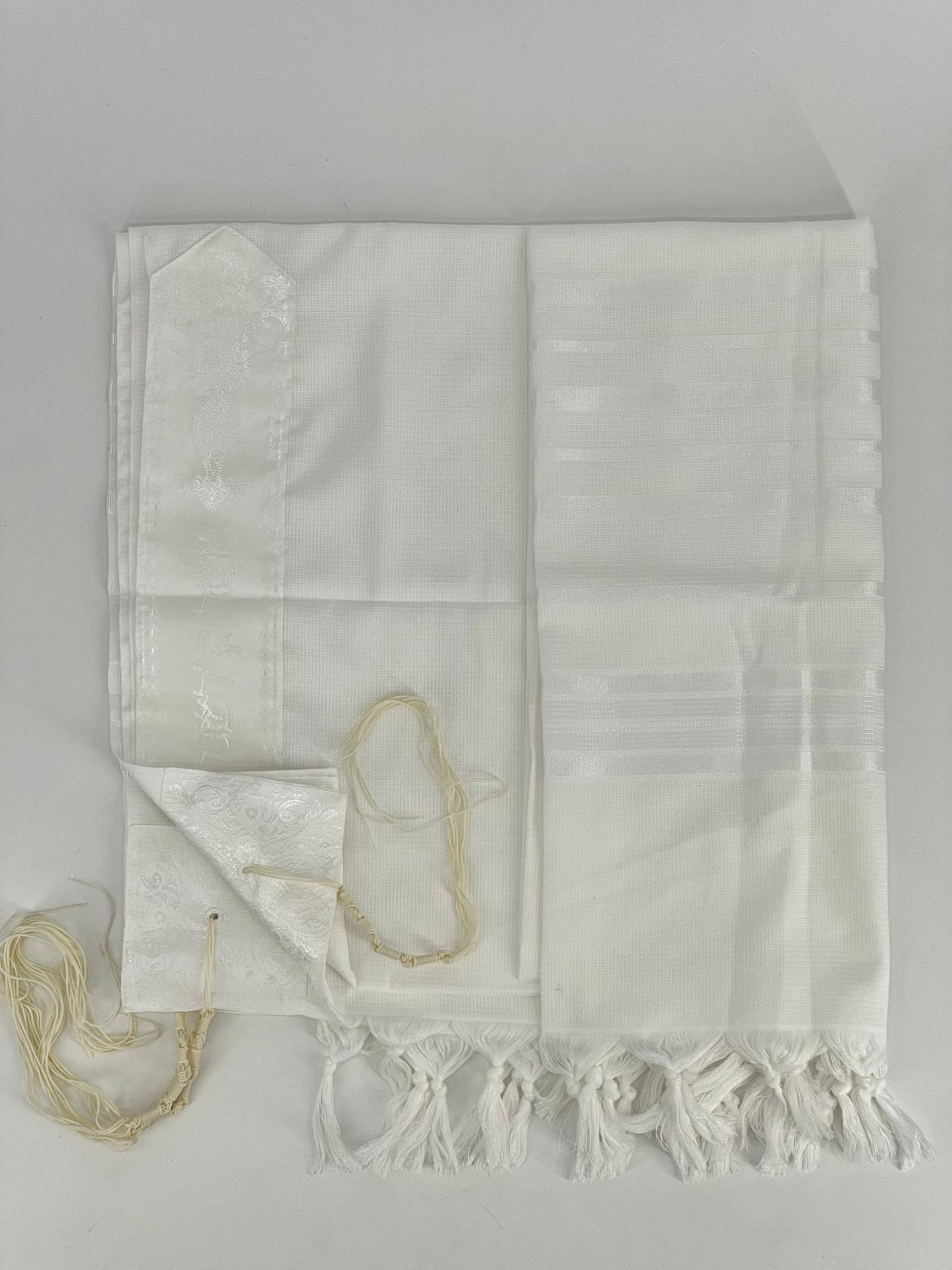 Flat-lay image of a white Acrylic Tallit Chatanim with white stripes and white decorative elements. T
