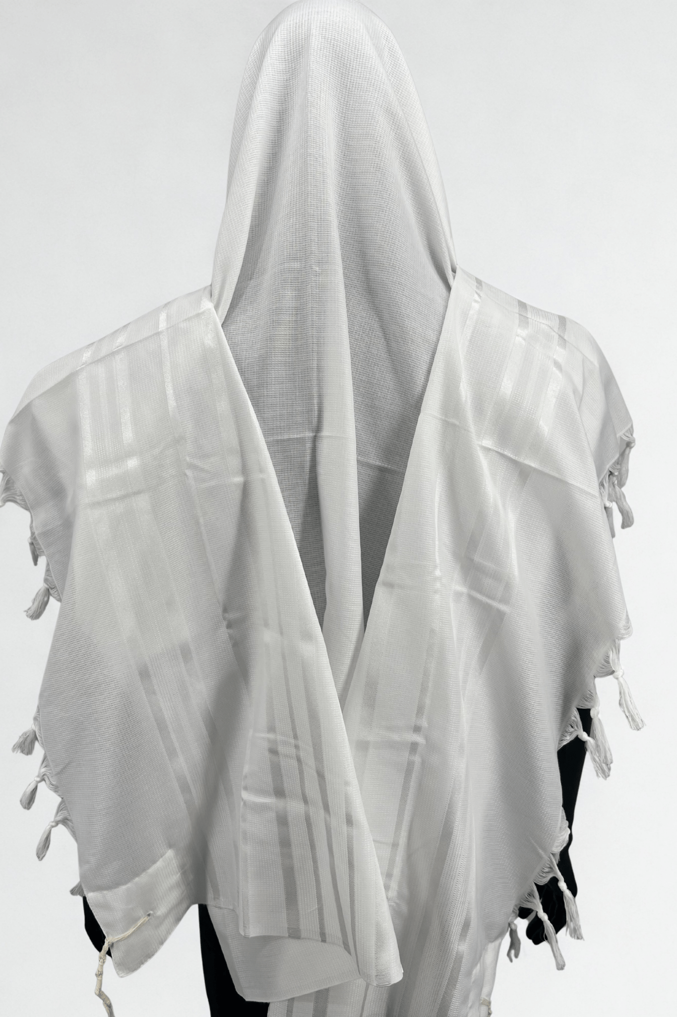 White prayer shawl with tassels on a white background