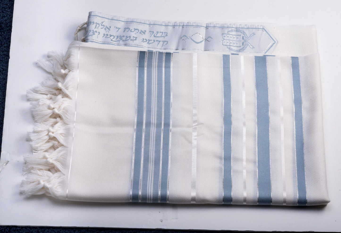 White wool tallit gadol with blue stripes on a white background