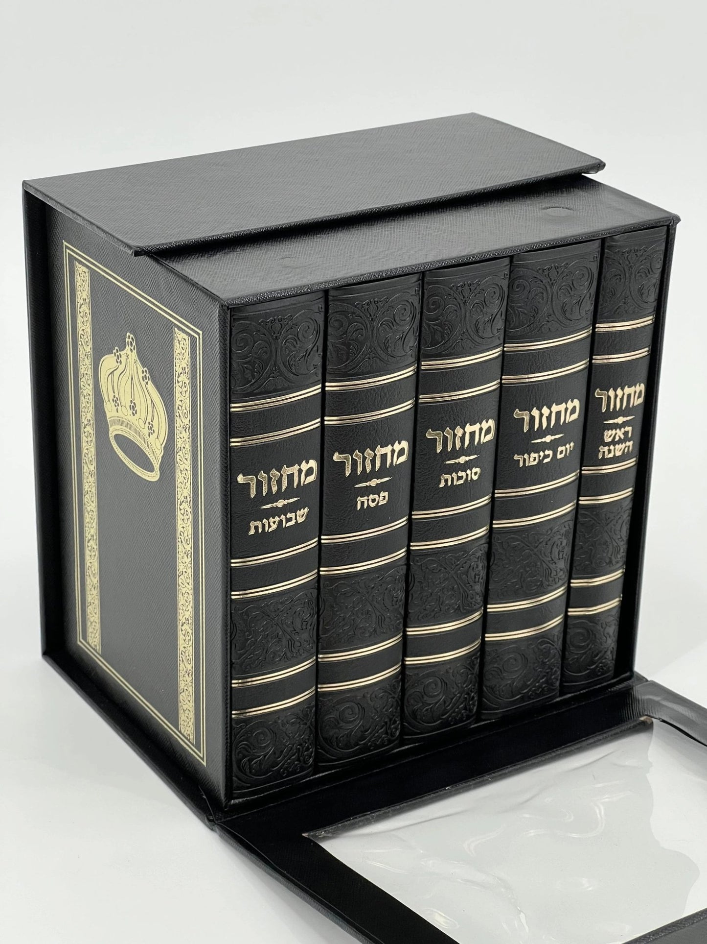 Five-volume Sha'arav B'Todah Sephardi Machzor set in an elegant black faux leather slipcase. Each volume has gold-embossed Hebrew text and a decorative crown design on the case. The set includes Machzorim for Rosh Hashanah, Yom Kippur, Sukkot, Pesach, and Shavuot.