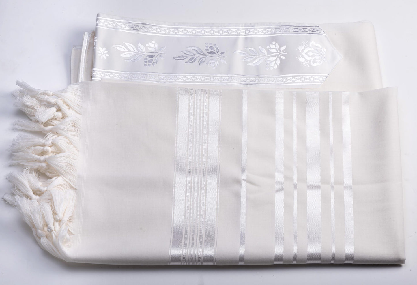 White wool tallit katan with embroidered patterns and tiztzit