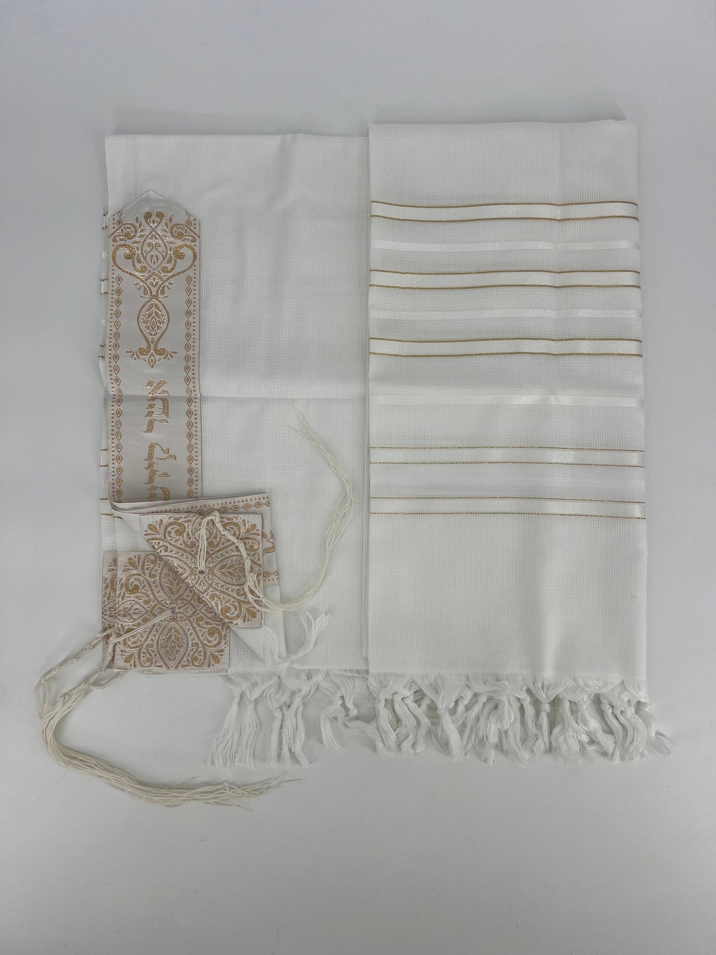 Flat-lay image of a white Acrylic Tallit Chatanim with gold stripes and gold decorative elements.