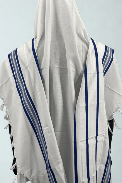 White prayer shawl with blue stripes on a light gray background
