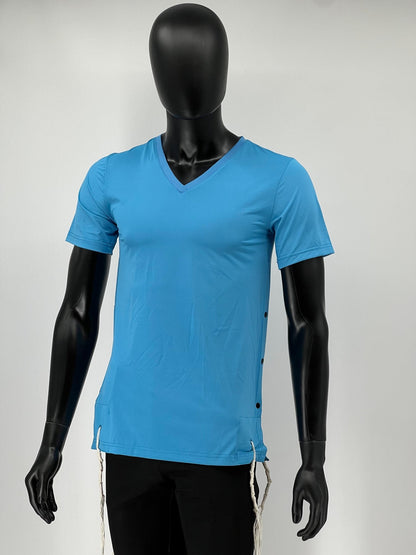 Mannequin wearing a bright blue V-neck short-sleeve Tzitzit T-shirt with black side buttons and white Tzitzit fringes hanging from the garment’s corners. The shirt is paired with black pants and displayed against a plain light background.