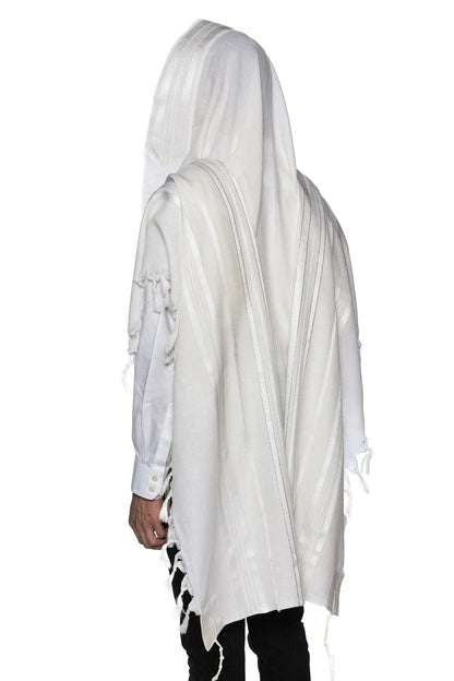 Man wearing a white wool Tallit with white stripes, draped over his head and shoulders