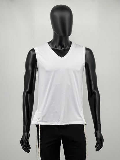 Mannequin wearing a white sleeveless tzitzit tank top and black pants on a gray background