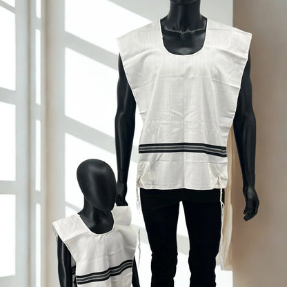 White sleeveless Chabad tallit katan  with black stripes on a mannequin against a neutral background
