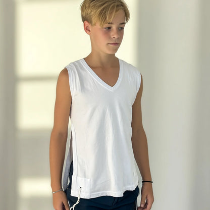 Boy wearing a white sleeveless Tzitzit T-shirt  against a neutral background