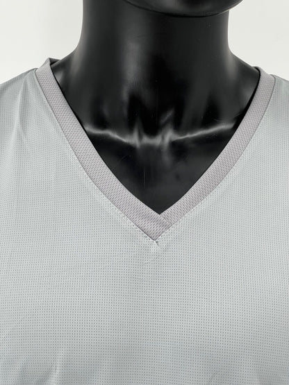 Close-up view of the neckline and upper chest area of a mannequin wearing a light gray V-neck Tzitzit T-shirt. The image highlights the ribbed collar and breathable, mesh fabric. Displayed against a plain light background.