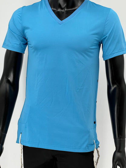 Front view of a mannequin wearing a bright blue V-neck short-sleeve Tzitzit T-shirt. The breathable fabric design features black side buttons and white Tzitzit fringes hanging from reinforced openings at the hem. The shirt is paired with black pants and displayed against a plain light background.