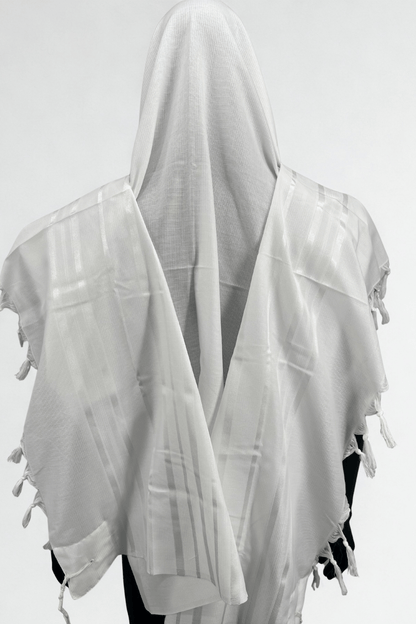 White prayer shawl with tassels on a white background