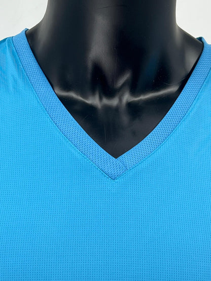 Close-up view of the neckline and upper chest of a mannequin wearing a bright blue V-neck Tzitzit T-shirt. The image highlights the ribbed collar and breathable, textured fabric. Displayed against a plain light background.