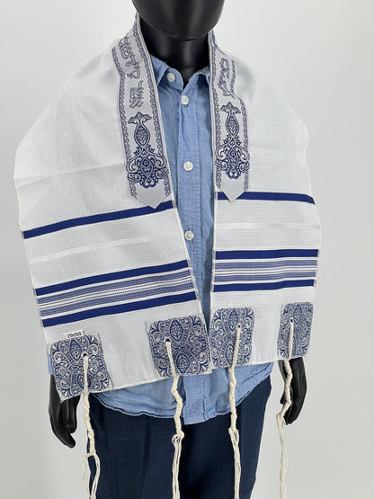 Child mannequin wearing a white children's tallit  with dark blue stripes and decorative blue embroidered corners