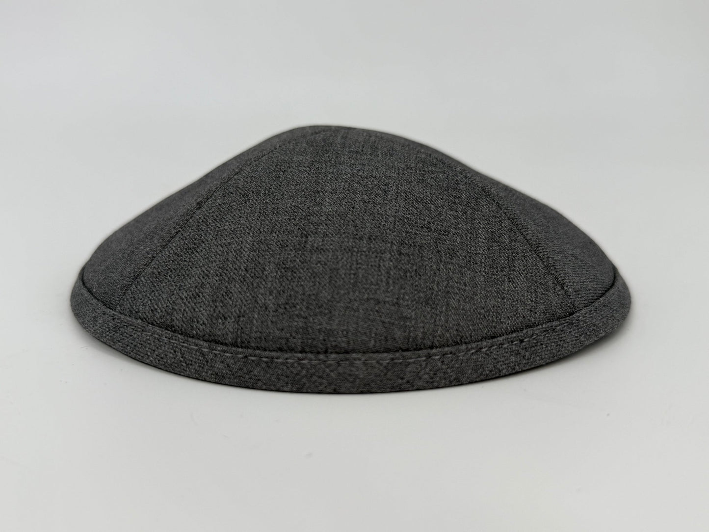 Dark gray kippah on a light gray background
