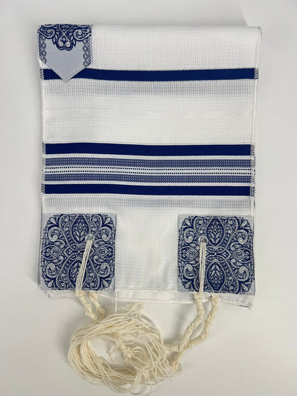 Folded white children's tallit (Jewish prayer shawl) featuring dark blue stripes, decorative silver corner reinforcements