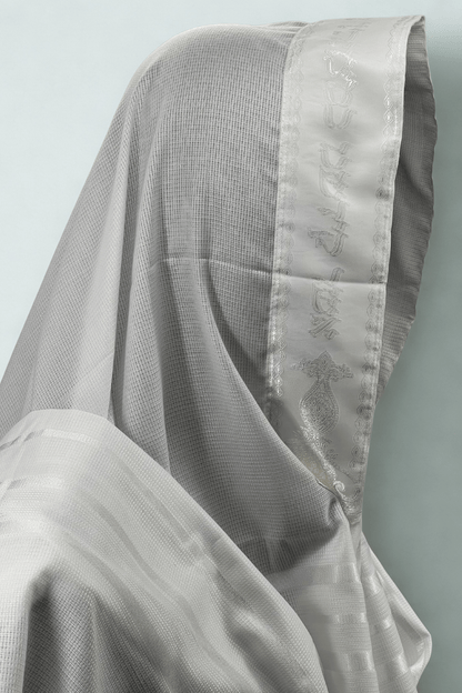 Close-up side view of a white Acrylic Tallit Chatanim with white stripes and an embroidered atara (neckband)