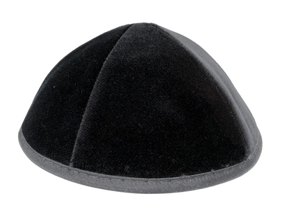Black velvet kippah on a white background