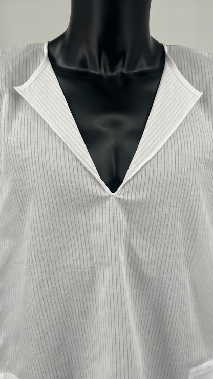 Close-up front view of a white cotton Tallit Katan worn on a black mannequin torso.