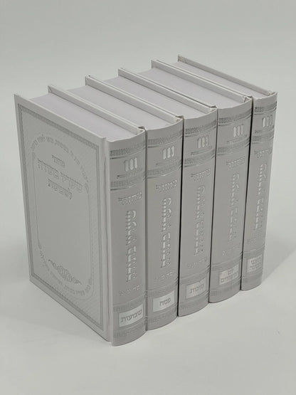 Five-volume Sha'arav B'Todah Sephardi Machzor set in glossy white faux leather with embossed silver Hebrew text and decorative details. Each volume includes prayers for a different Jewish holiday: Rosh Hashanah, Yom Kippur, Sukkot, Pesach, and Shavuot.