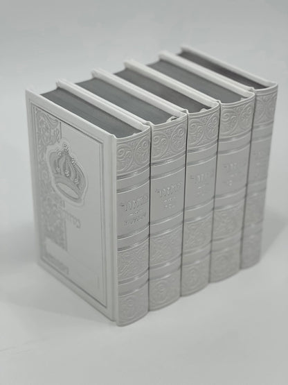 Five-volume Sha'arav B'Todah Sephardi Machzor set in elegant white faux leather with embossed Hebrew titles and crown design. Each volume corresponds to a major Jewish holiday: Rosh Hashanah, Yom Kippur, Sukkot, Pesach, and Shavuot. Decorative detailing enhances the spine and cover.