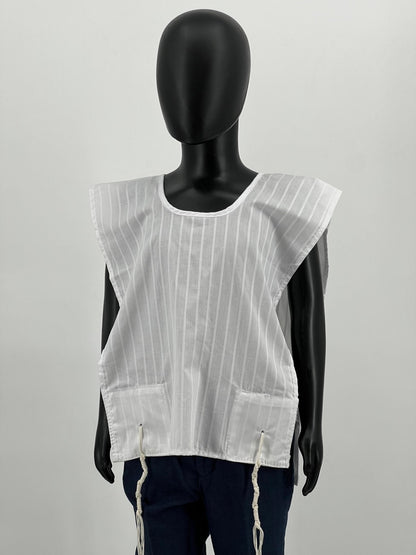A white poly-cotton Tallit Katan with vertical stripes, shown on a black mannequin with reinforced corners and tzitzit