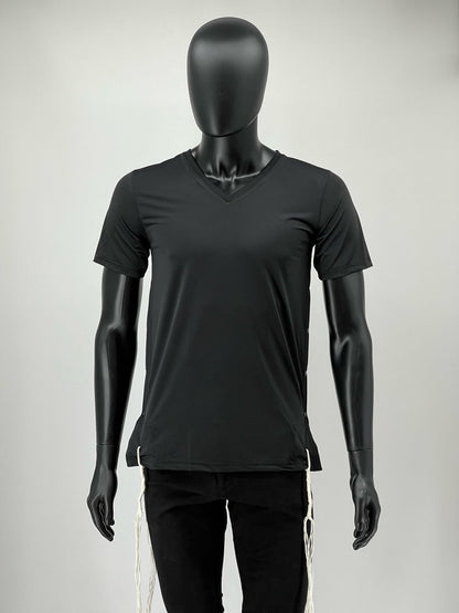 Front view of a mannequin wearing a black V-neck moisture-wicking Tzitzit T-shirt with white Tzitzit strings hanging from the corners. The shirt has a modern, athletic fit designed for everyday comfort.