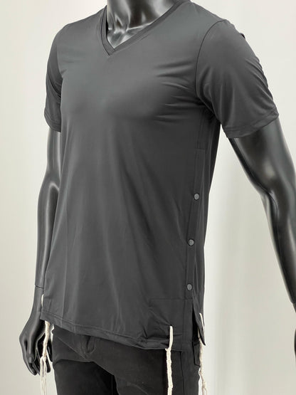 Black moisture-wicking V-neck Tzitzit T-shirt displayed on a mannequin. The shirt features a sleek athletic cut, discreet side buttons for ease of wear, and visible Tzitzit strings extending from the hem.