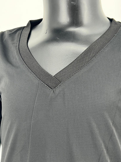 Close-up view of a mannequin wearing a black V-neck Tzitzit T-shirt made from breathable, mesh fabric. The image highlights the neckline, stitching, and texture of the upper chest area. Displayed against a plain light background.