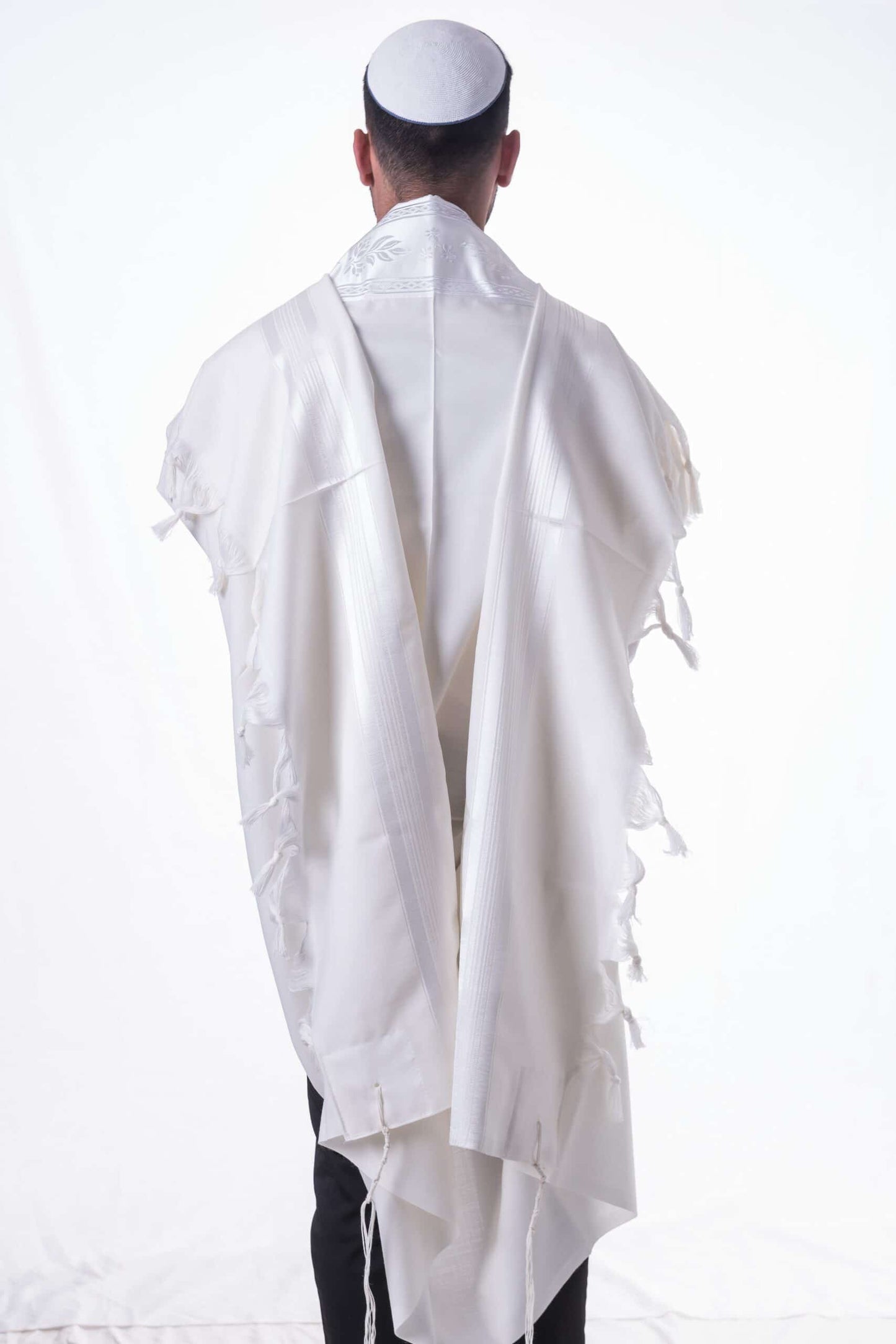 Person wearing a white prayer shawl (Tallit)  on a white background