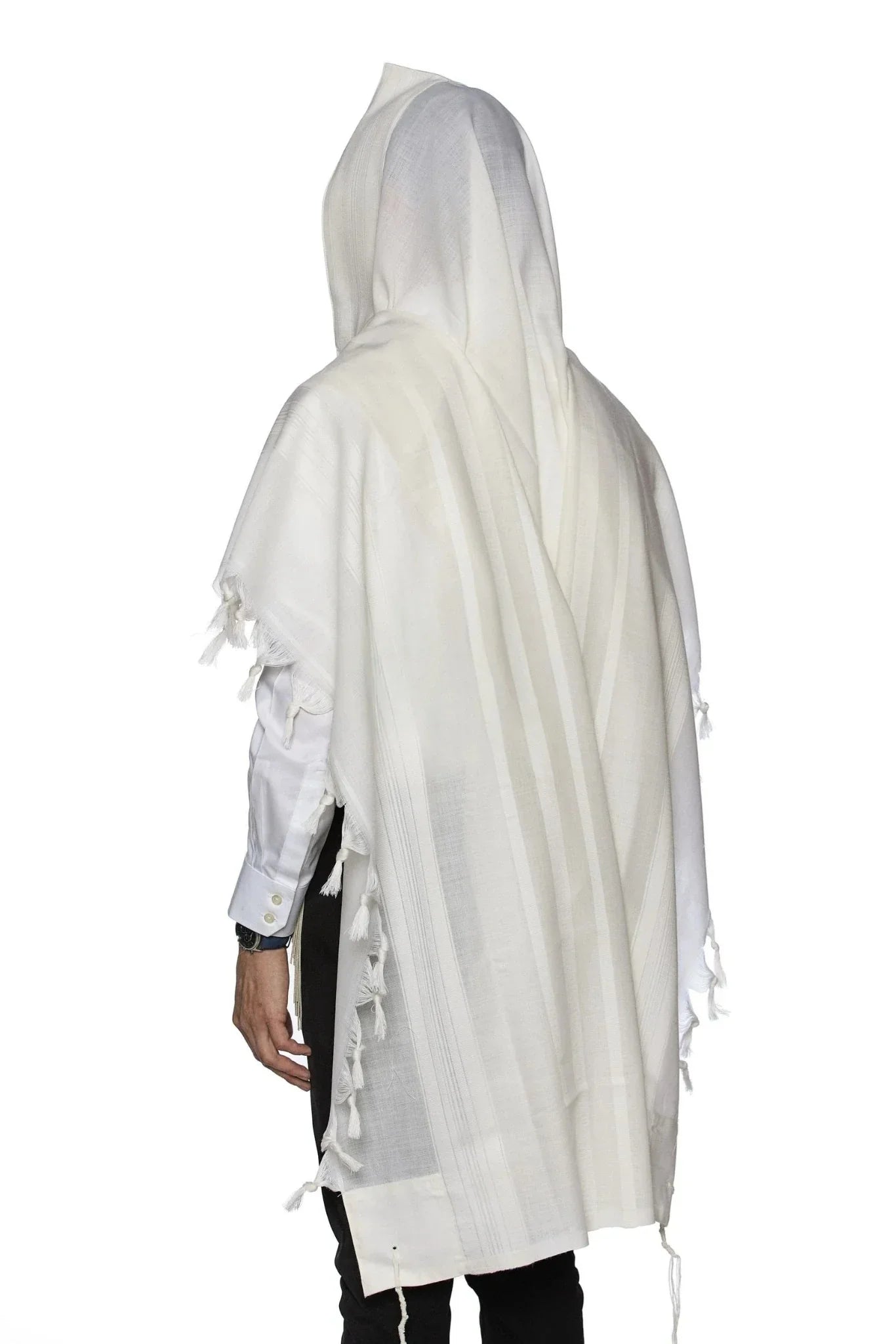 Man wearing a traditional white wool Tallit, draped over his head and shoulders during prayer.