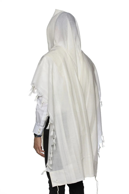 Man wearing a traditional white wool Tallit, draped over his head and shoulders during prayer.