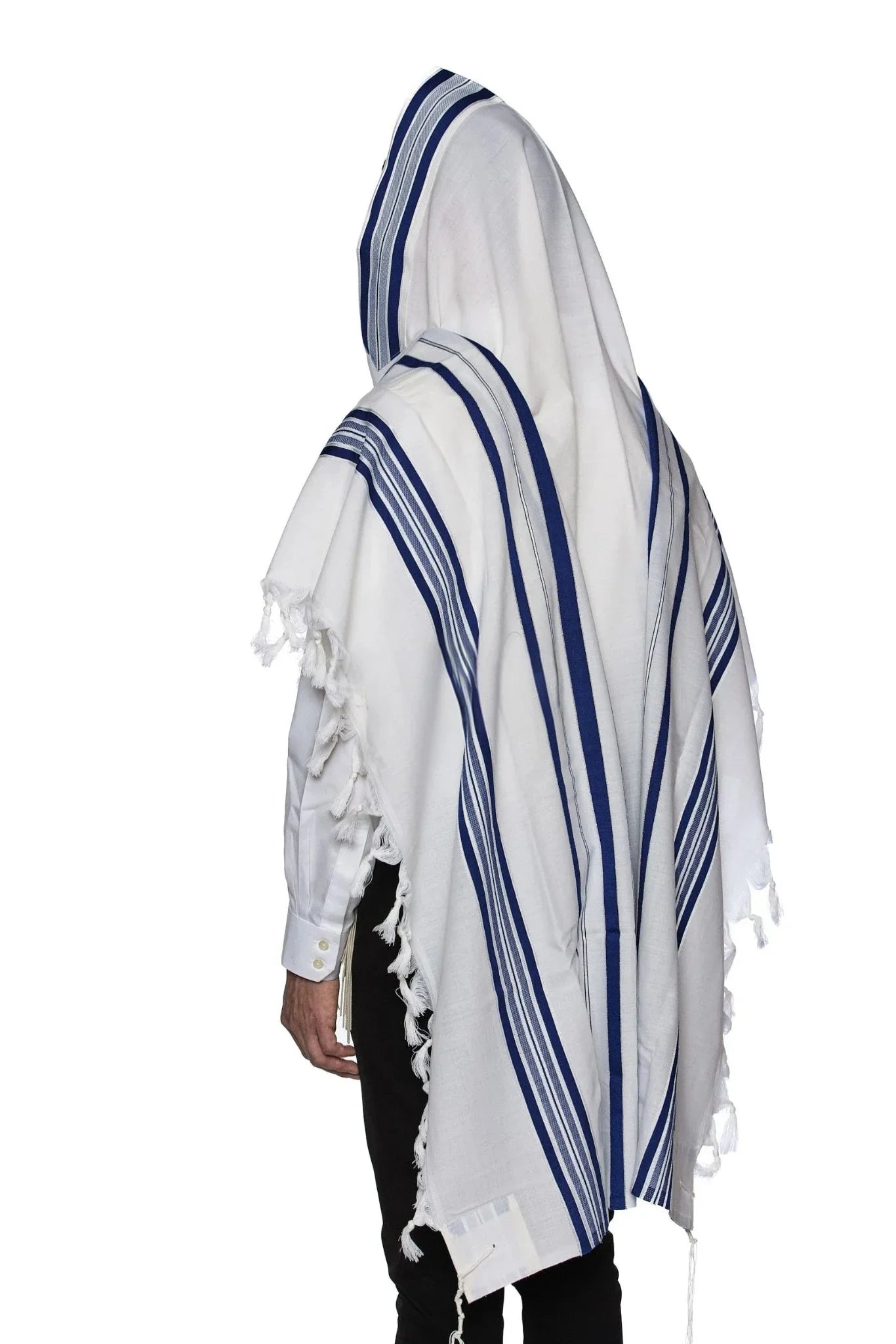 Man wearing a traditional white wool Tallit with blue stripes, draped over his head and shoulders during prayer.