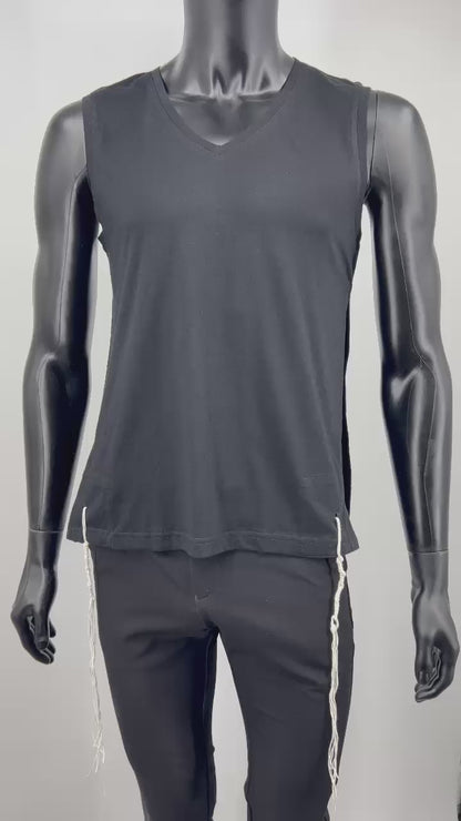 Video of a mannequin wearing a black sleeveless V-neck Tzitzit T-shirt vest paired with black pants. White Tzitzit fringes hang from all four corners of the garment, in accordance with traditional Jewish practice. Displayed against a plain light background.